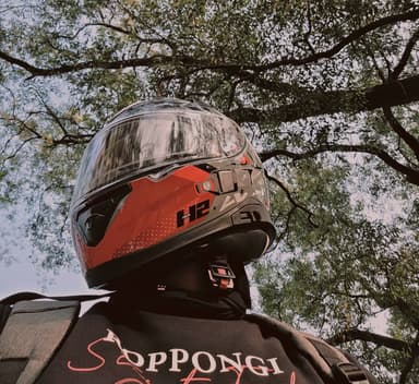 Aditya Gupta in a red motorcycle helmet